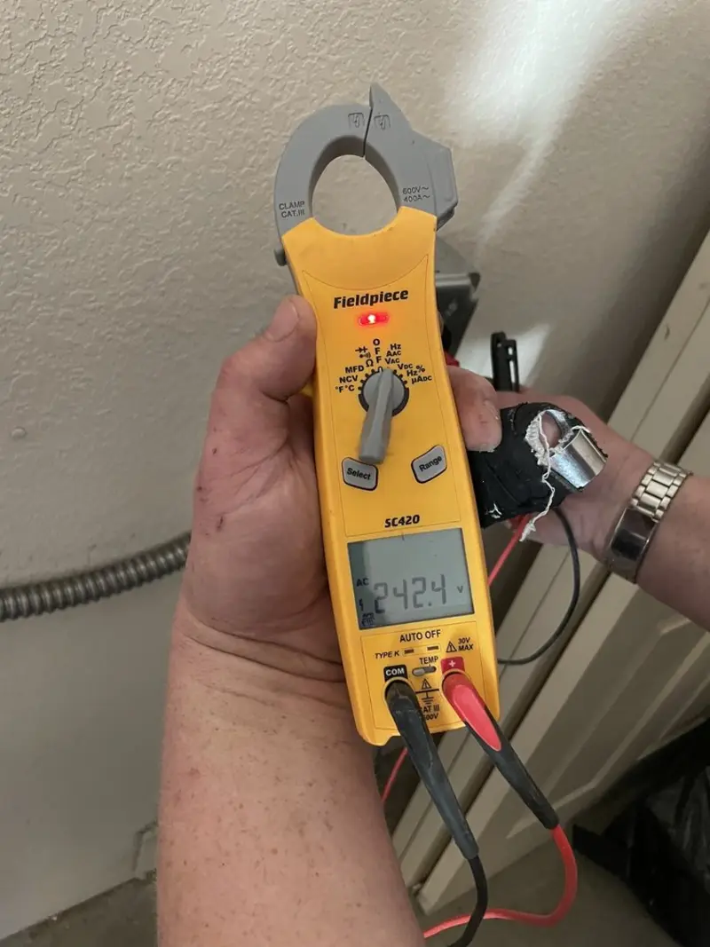 Voltage testing with clamp meter during Recessed Lighting Installation in Miami